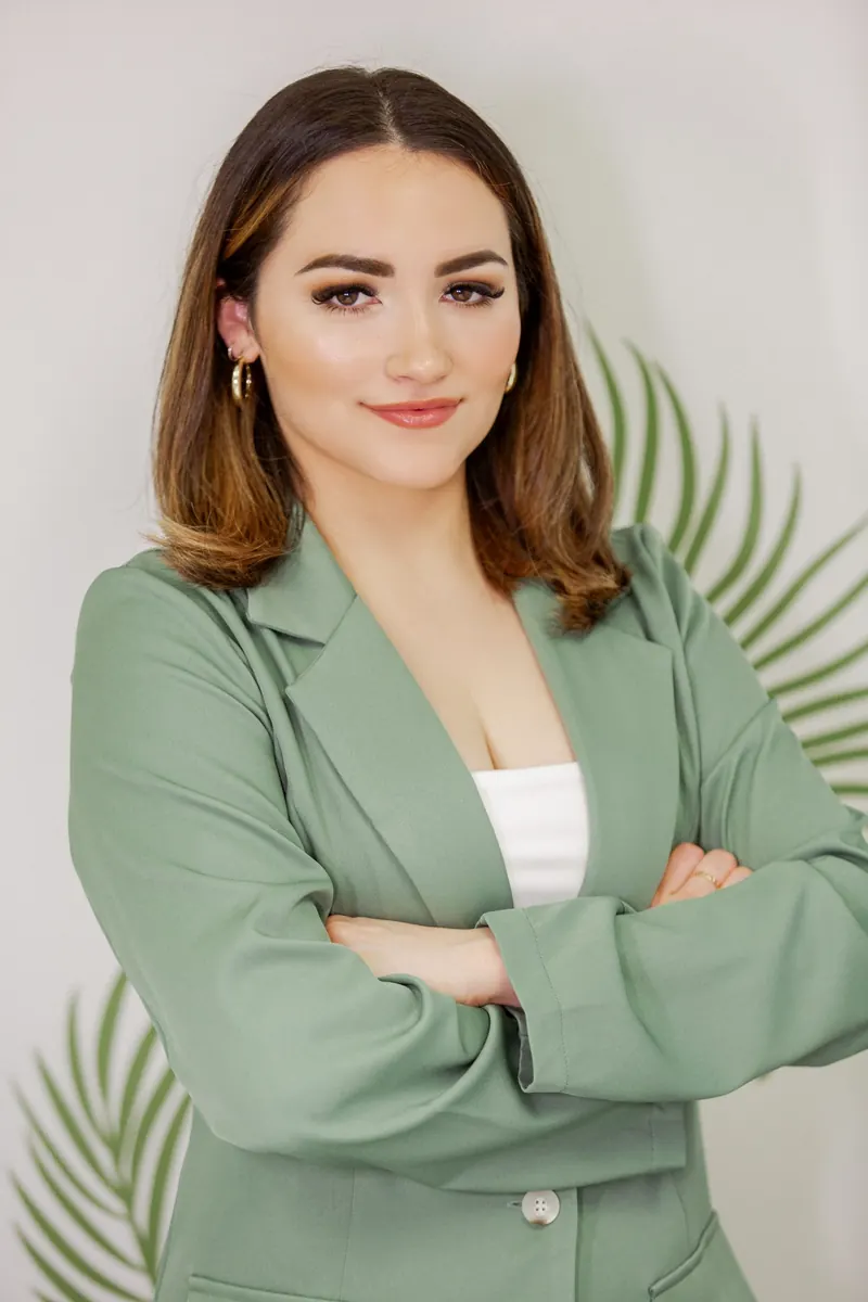 Professional headshot of a woman in a green blazer